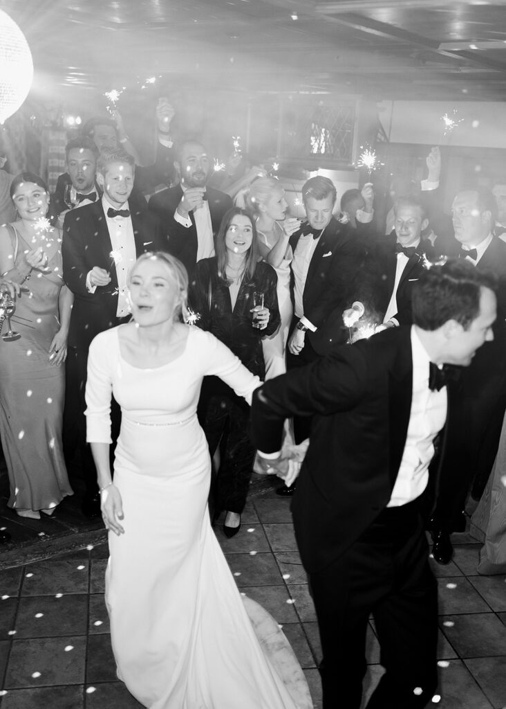 A bride and groom dance happily, surrounded by guests with sparklers at a magical wedding celebration in the picturesque Lake Constance region.